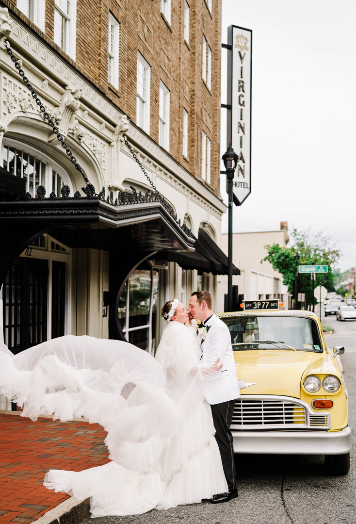 Classic taxi at the Virginian Hotel in Lynchburg with wedding couple, courtesy Kaitlyn Lane Photography